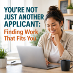 Job seeker smiling while using a laptop at home representing finding the right job fit and personalized employment opportunities